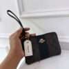 COACH CORNER ZIP WRISTLET SINGNATURE CANCAS